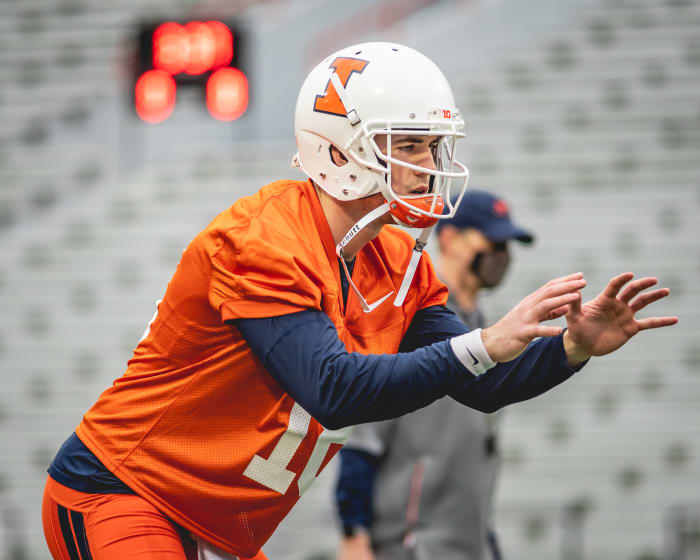 Illinois senior quarterback Brandon Peters taking a snap during the first spring practice on March 23, 2021.